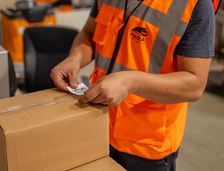 muncitor ce efectueaza operatiunea de etichetare in depozitul RARA Logistic din Sibiu Sura Mica
